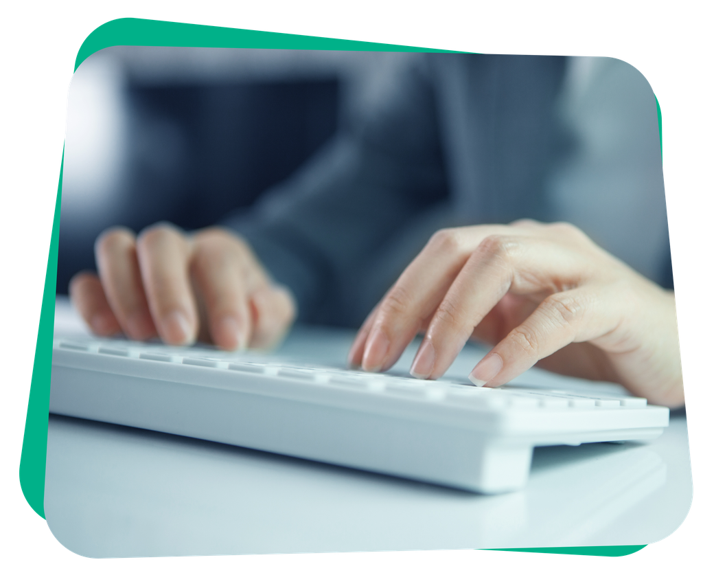 Hands typing on a white keyboard with a blurred background, suggesting focus and productivity.