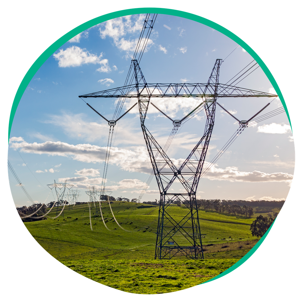 Powerlines with green hills in the background.